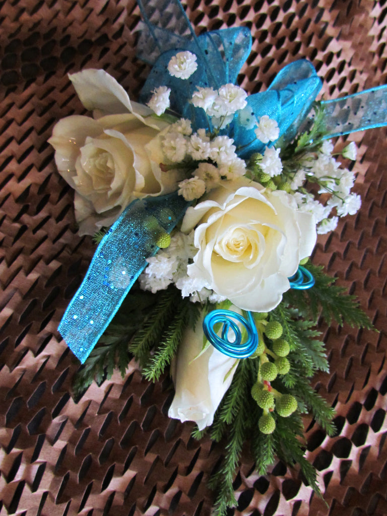 Corsage with rose, baby's breath, and ribbon