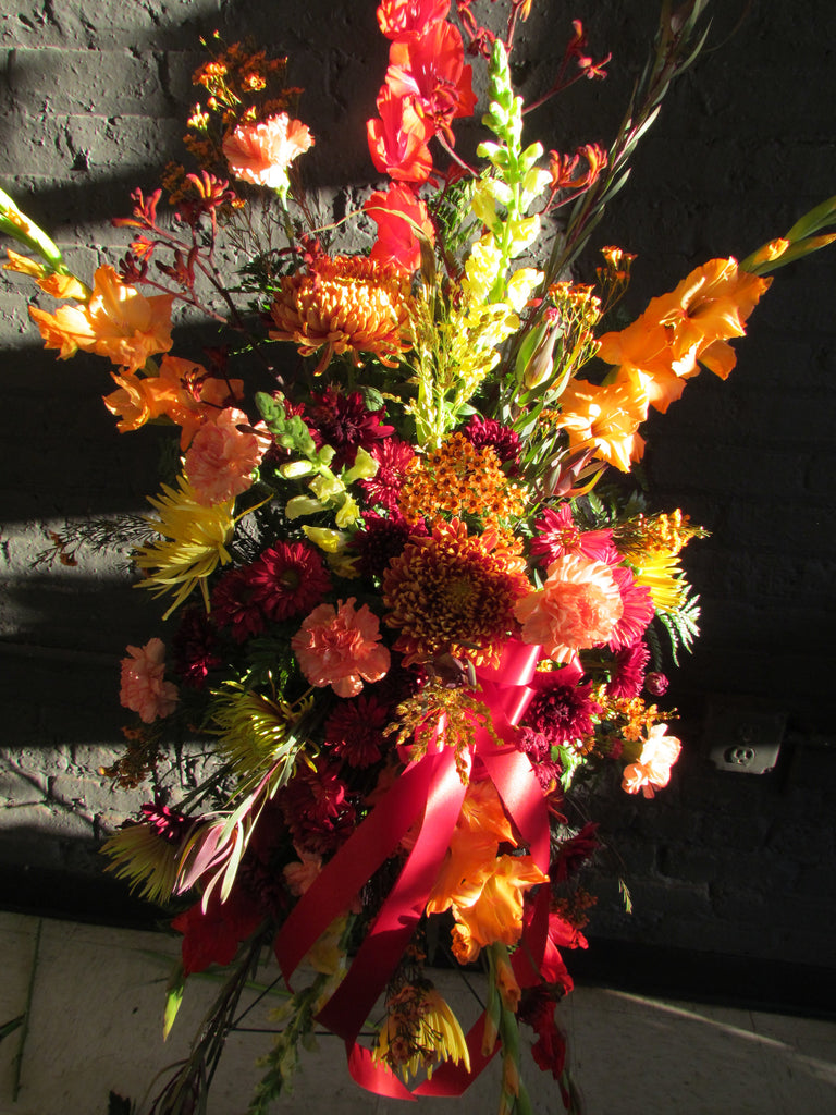 Fall colored casket spray with ribbon