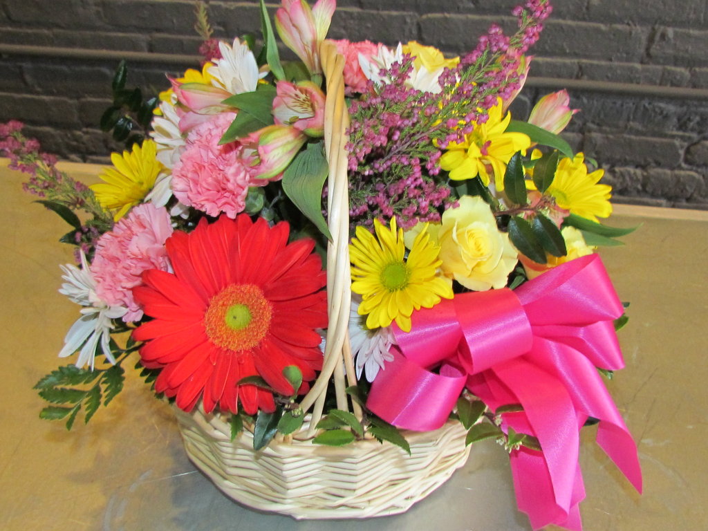 Basket full of bright colors with bows