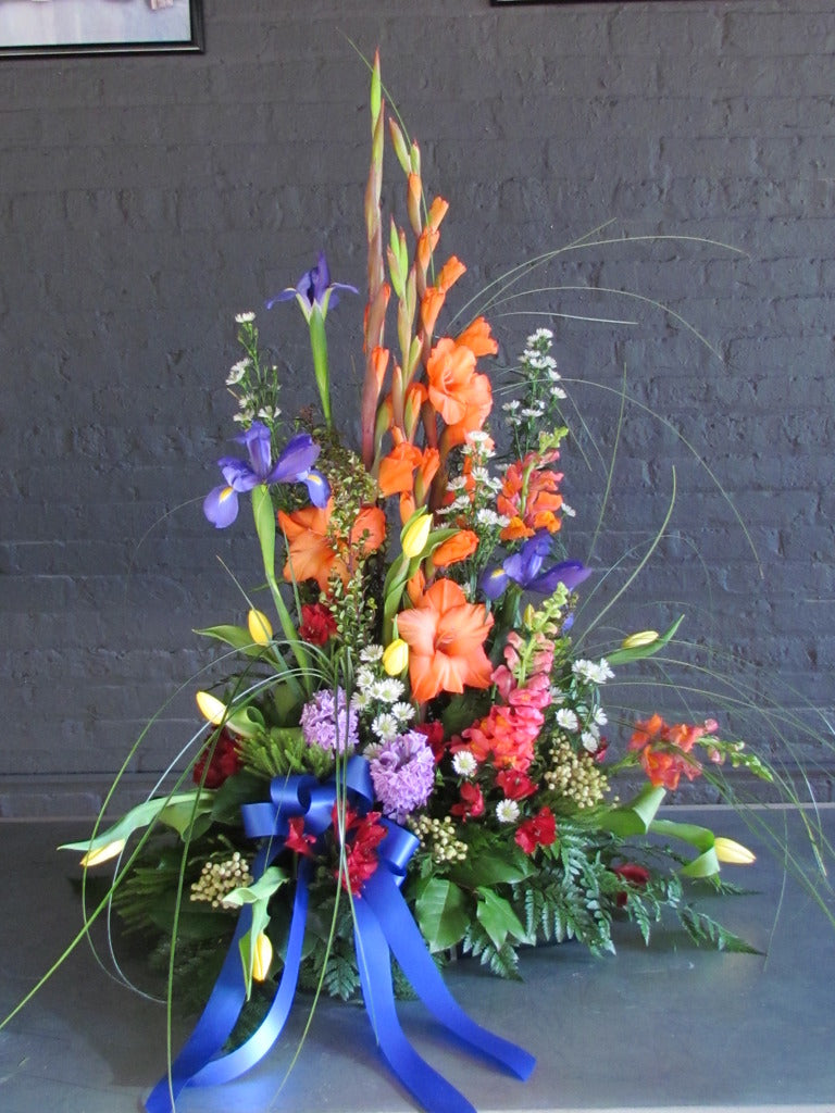 Beautiful tall and bright traditional funeral arrangement