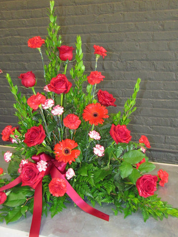 Red, tall, traditional funeral arrangement 