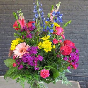 Large fresh bouquet arranged in glass vase